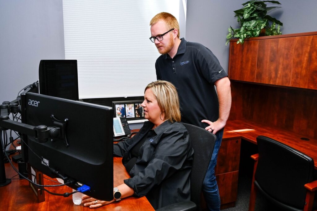 Justin white next to michelle white looking at computer screen