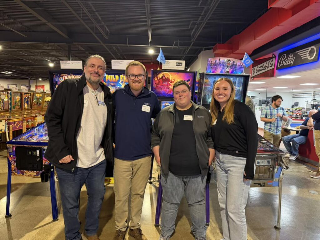 group of ATp employees at pinball place smiling
