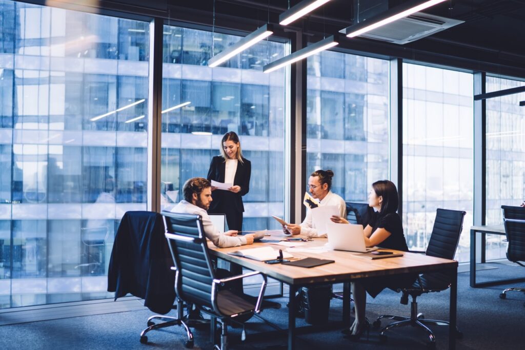 Group of business professionals sitting at desk during meeting