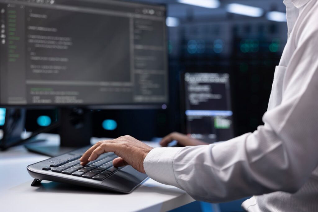 Man typing on computer keyboard
