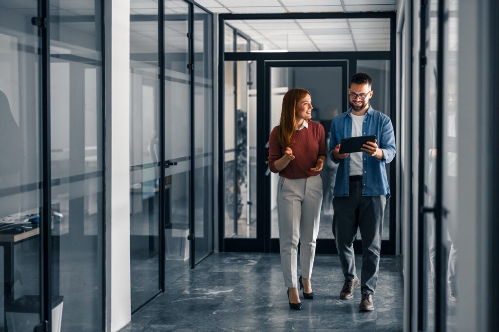 Man and women walking down hallway