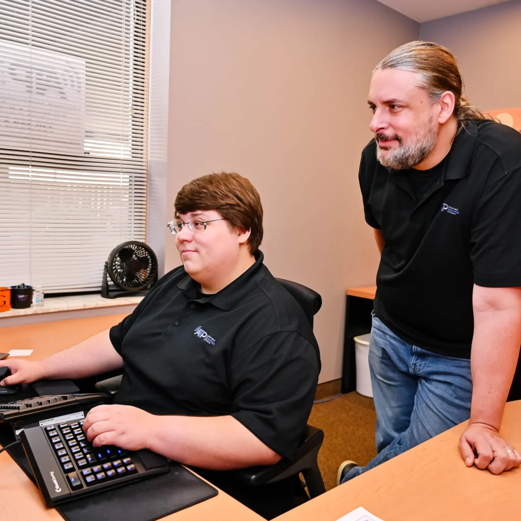 Two ATP employees working at desk